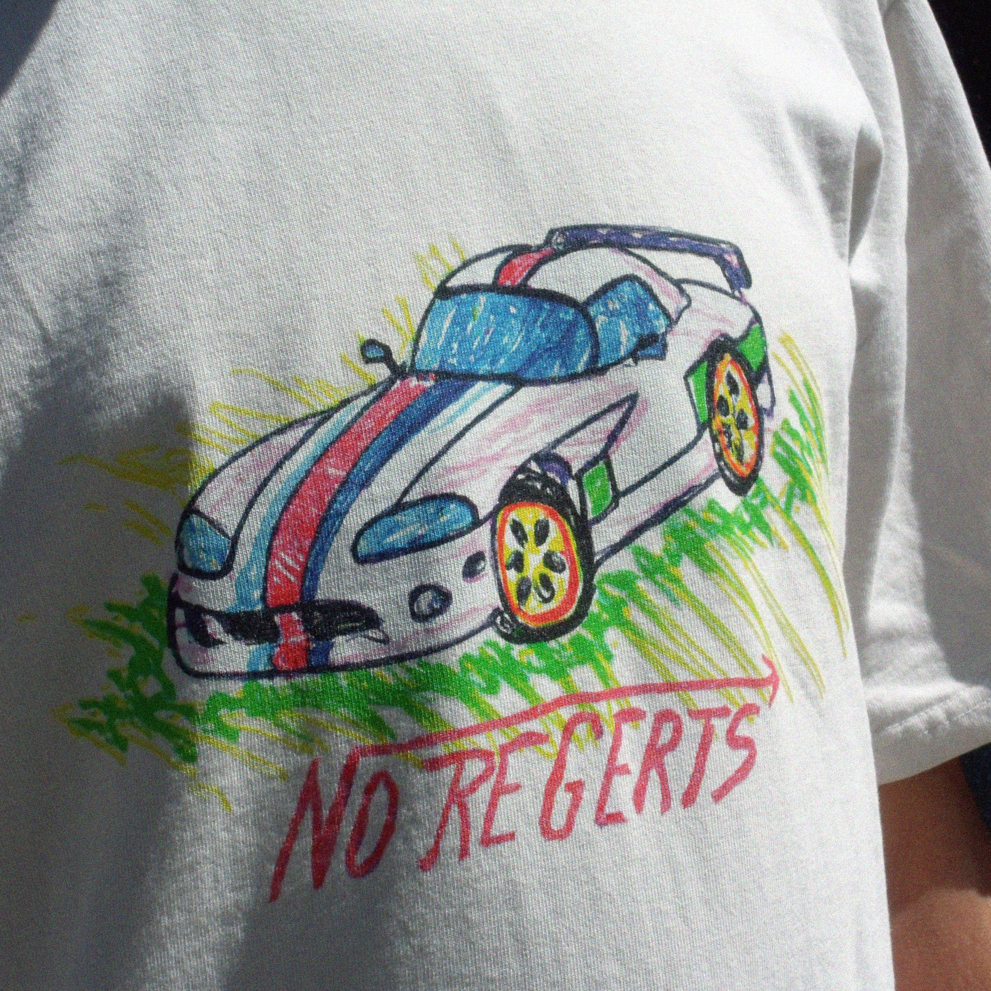 Front print close up of the Oversize fit unisex t-shirt in Bone Color - with naive crayon style Dodge Viper bootleg print in childlike drawing and a tag-style writing saying "No Regerts"