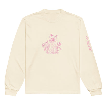 Front view of the Netcopia's "You Sarcastic Little Fuck" Unisex Premium Heavyweight Long Sleeve Cotton Crewneck T-Shirt in Ecru, depicting a evil faced cat surrounded by flowers on the chest in pink, and rough lettering printed on the left sleeve, also in pink