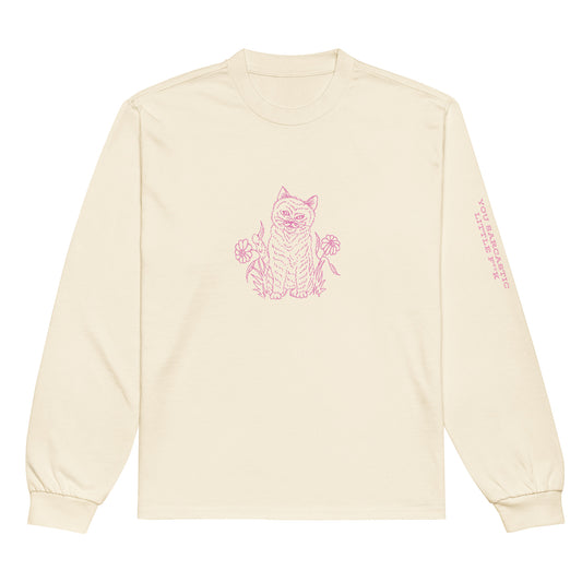 Front view of the Netcopia's "You Sarcastic Little Fuck" Unisex Premium Heavyweight Long Sleeve Cotton Crewneck T-Shirt in Ecru, depicting a evil faced cat surrounded by flowers on the chest in pink, and rough lettering printed on the left sleeve, also in pink